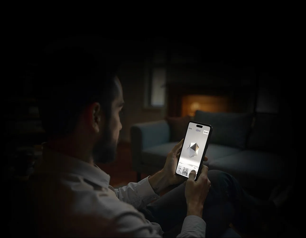 Person in a dark room holding a phone that shows the Cinco AI app