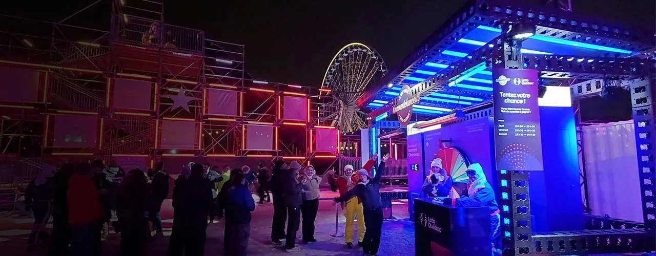 Loto-Québec festival activation at night with crowds and neon signage