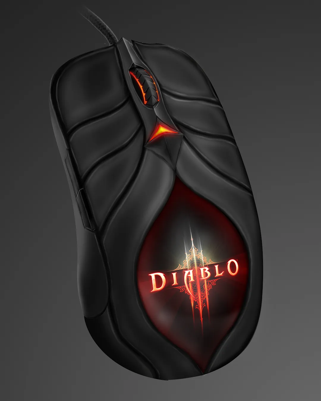 Diablo III gaming mouse, angled, with a glowing red emblem and tribal detailing