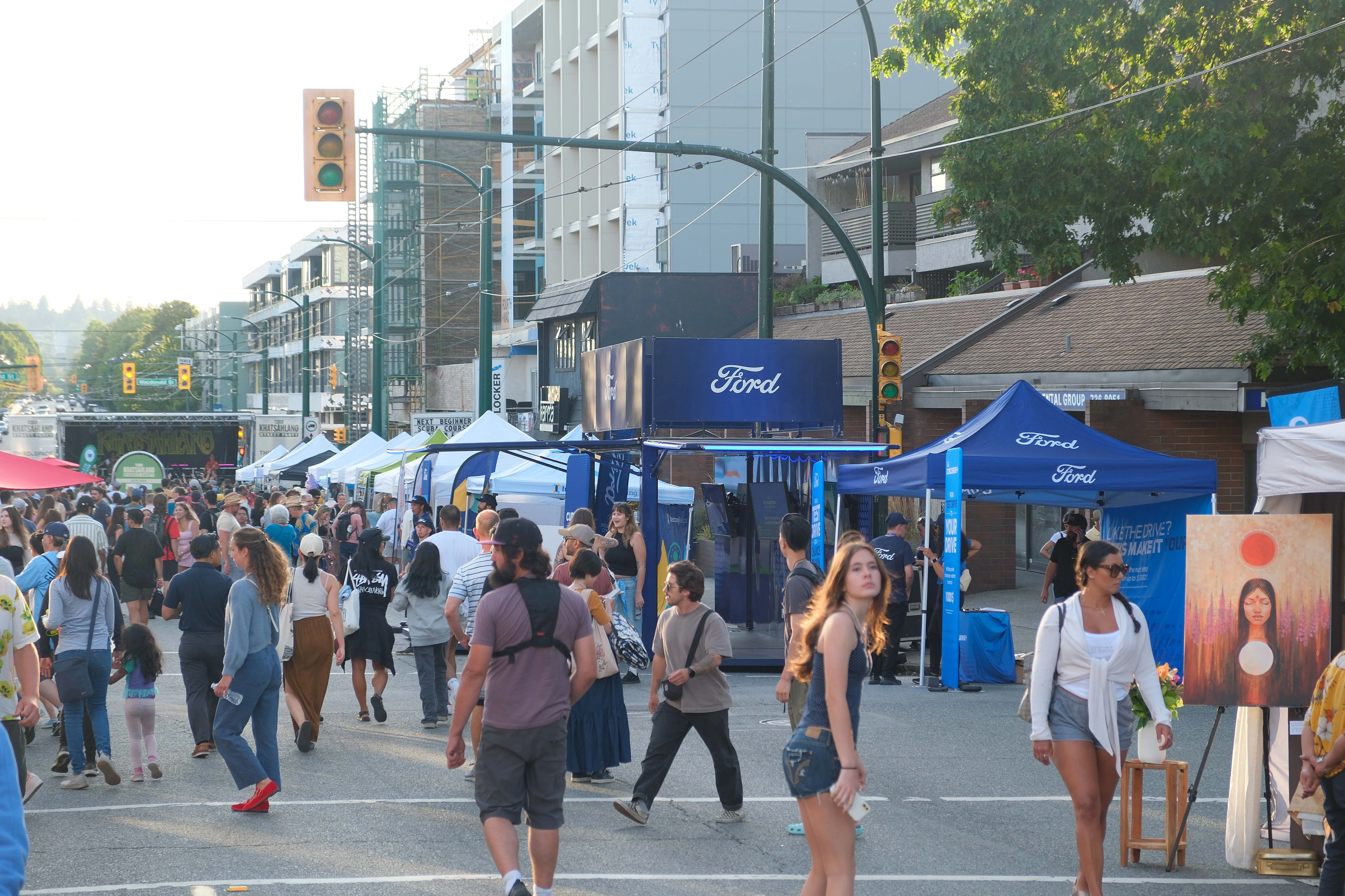 Crowd at an urban festival with blue Ford event tents