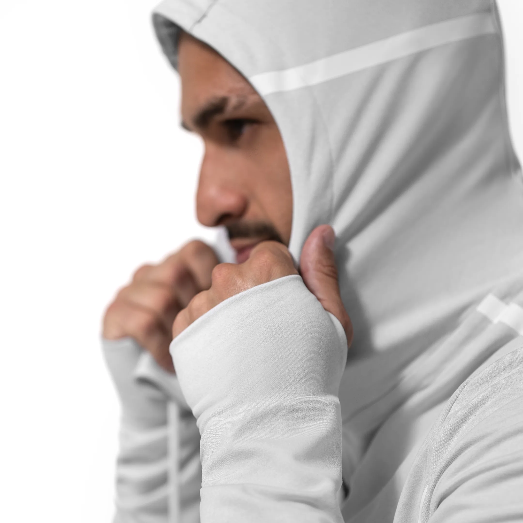 Close-up of a man in a white Hayabusa hoodie showing fabric detail and cuff branding