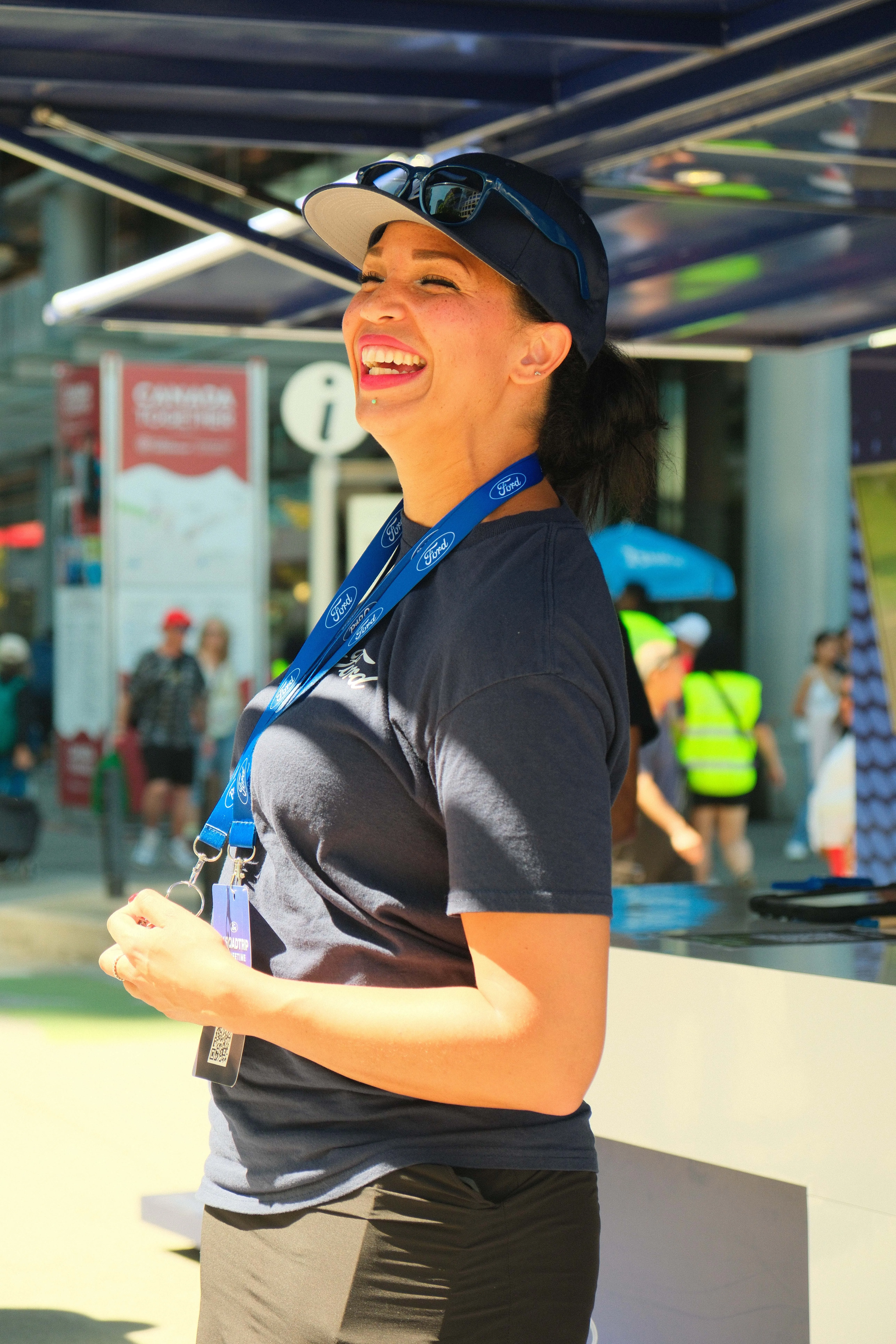 Smiling Ford staff member in a blue shirt inside the booth