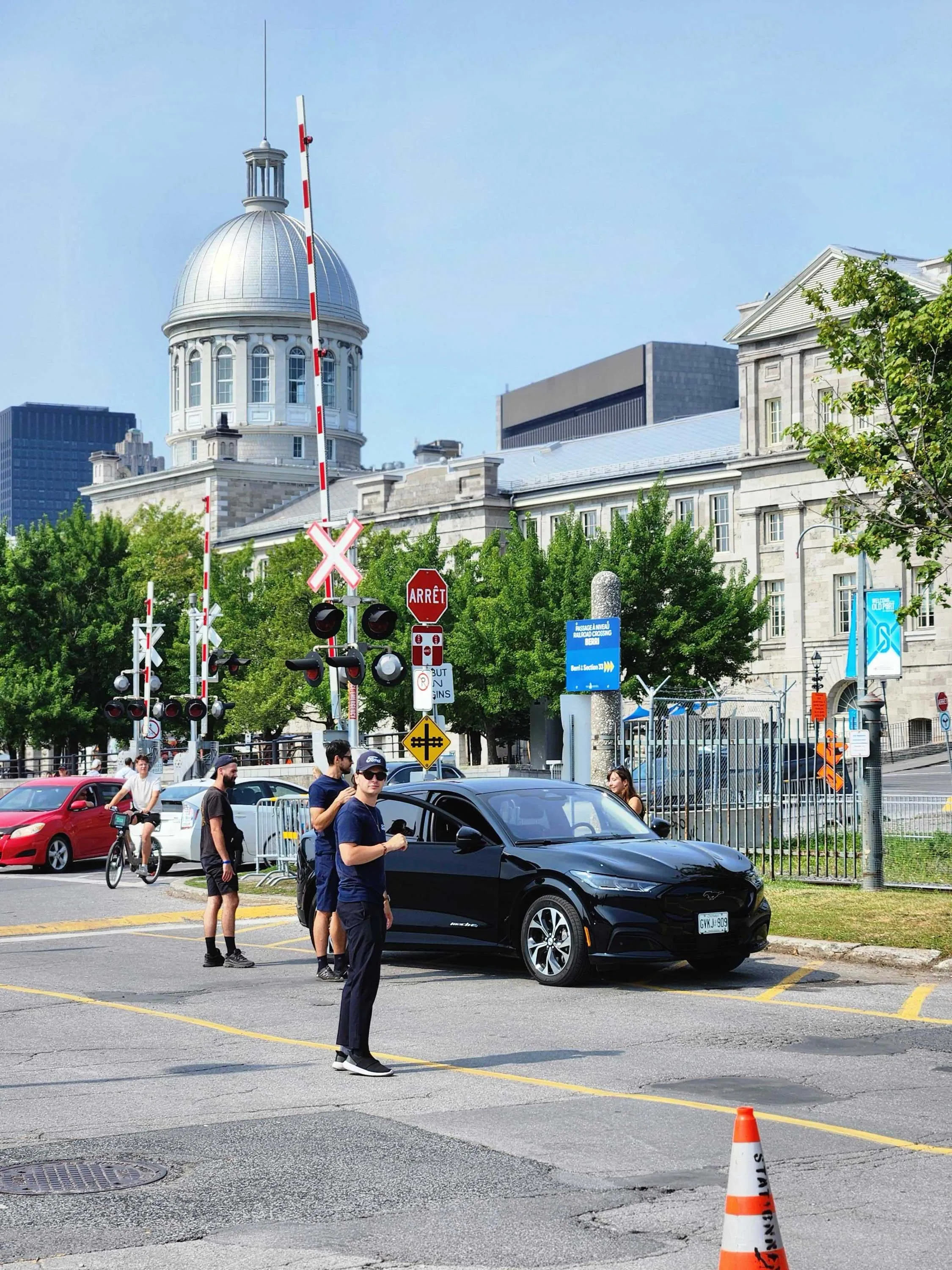 Black Ford electric vehicle near a historic city building