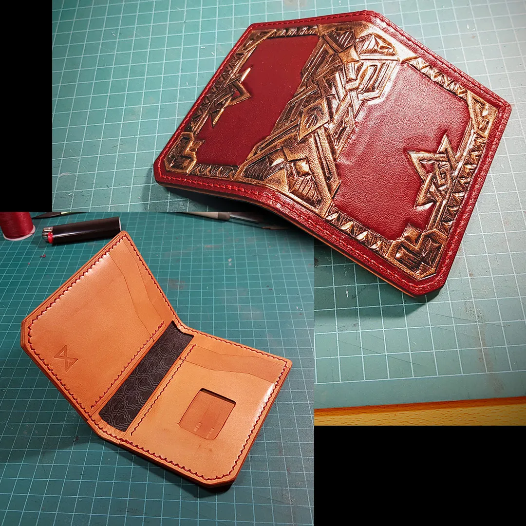 Two red leather wallets with a carved geometric mountain design