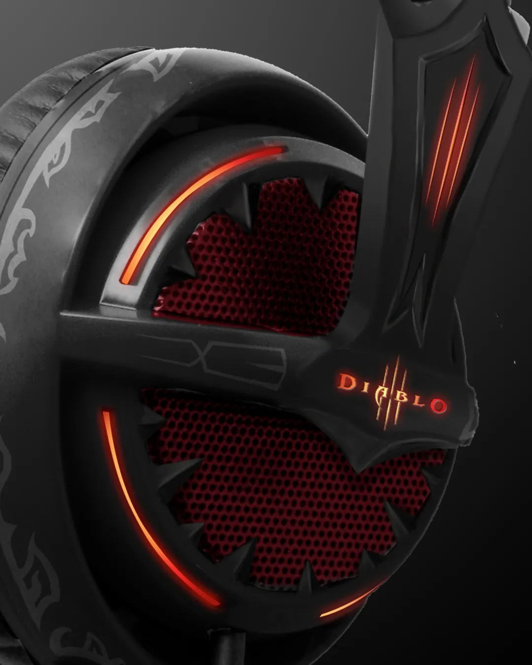 Diablo III headset ear-cup detail with a red mesh grille and orange LED glow