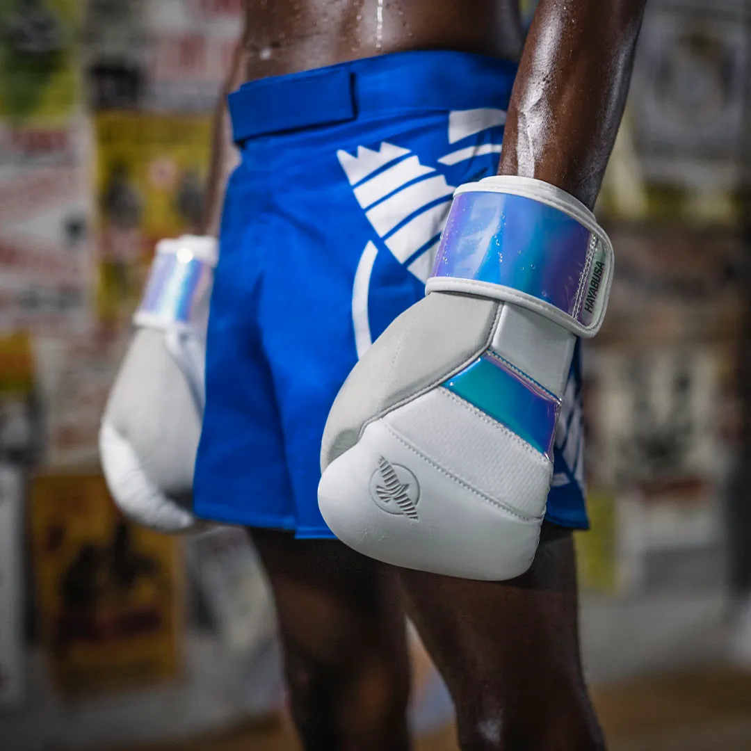 Hands wrapped in blue and white Hayabusa boxing gloves